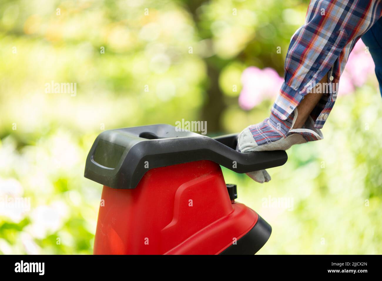 Garden chipper, electric shredder mulcher against the background of the