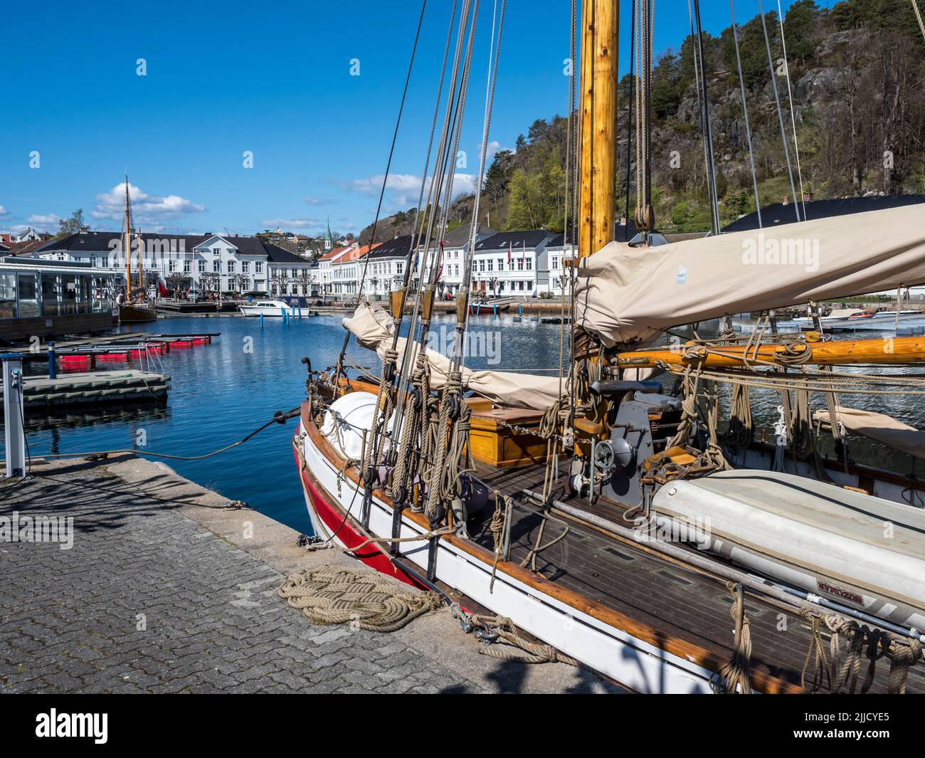 At the seaside in Risor, a traditional village with wooden white houses ...