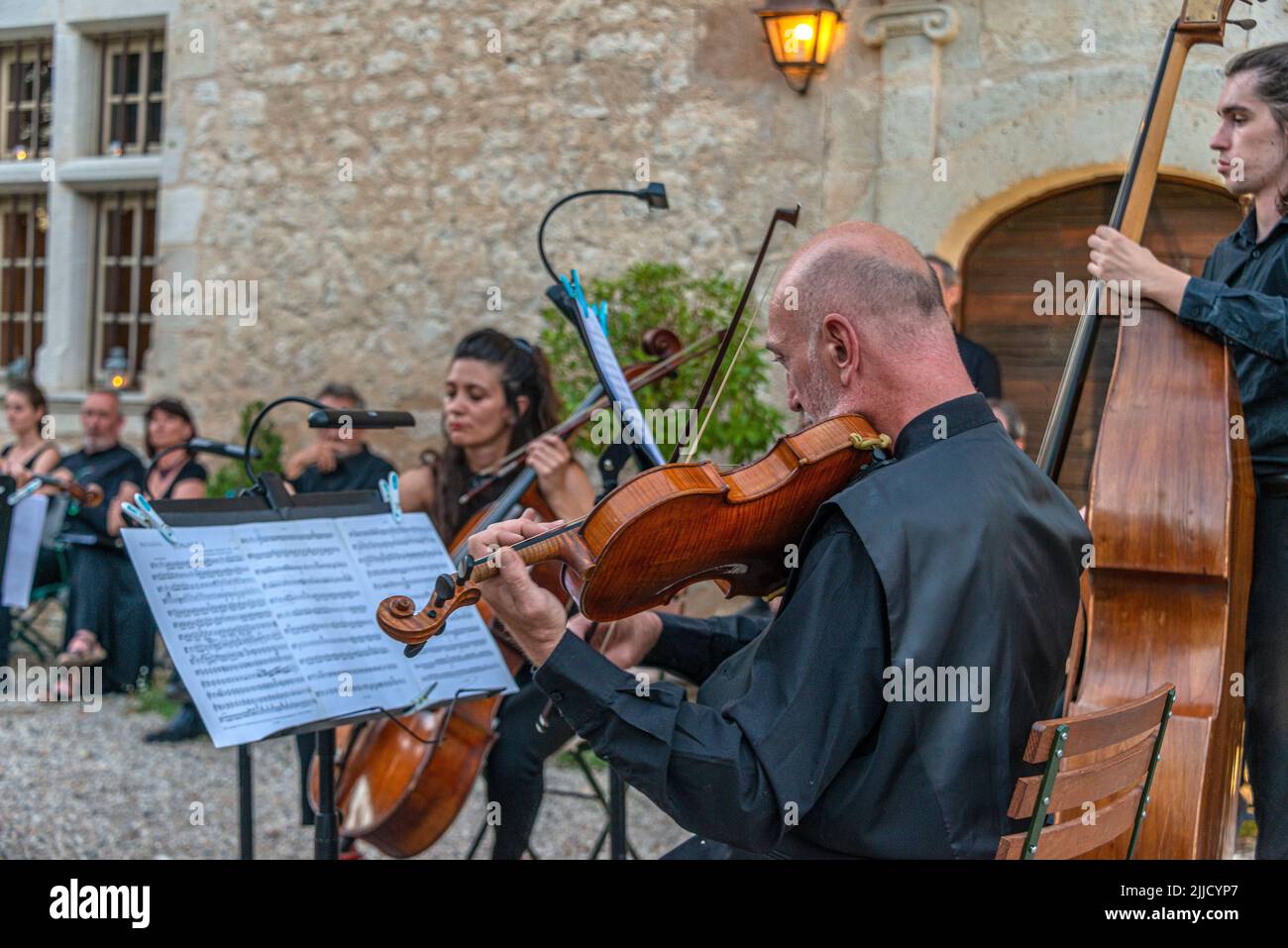 Violinist at work in an outdoor summer concert. Chateau Mayragues in the south of France. Stock Photo