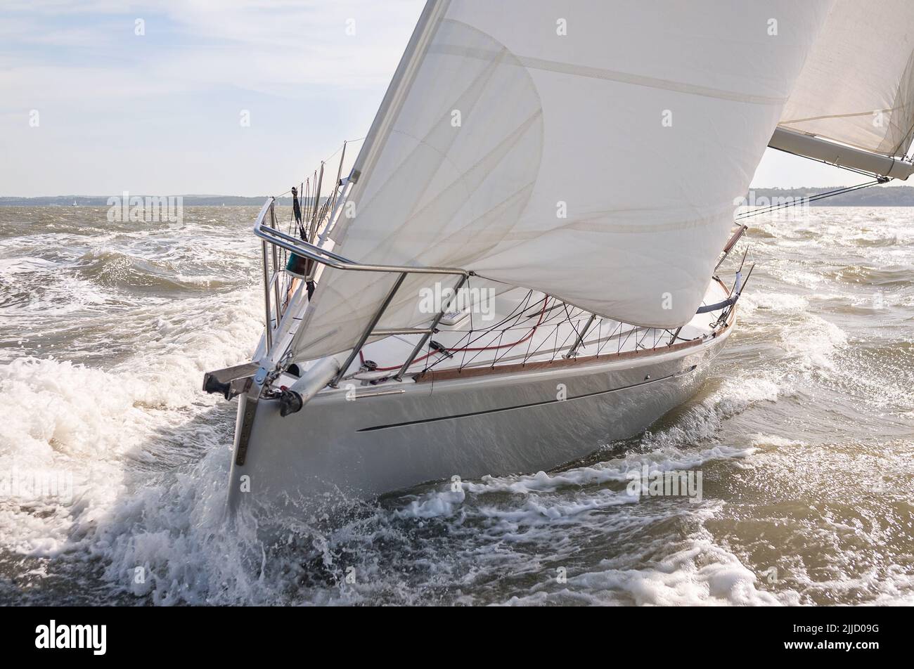Close up of sailing boat, sail boat or yacht on a rough sea with white sails Stock Photo