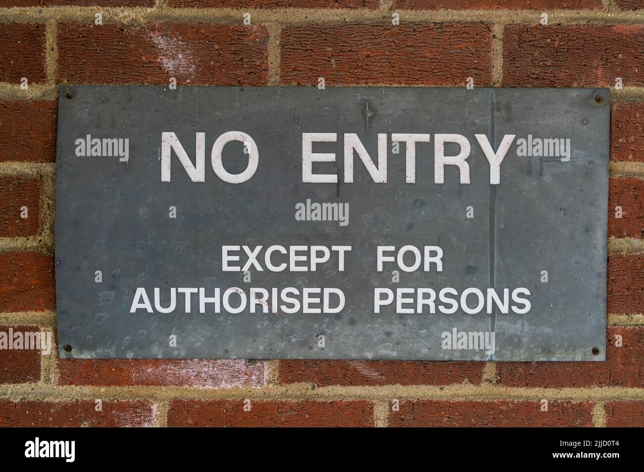 Old metal No Entry sign on a brick wall Stock Photo