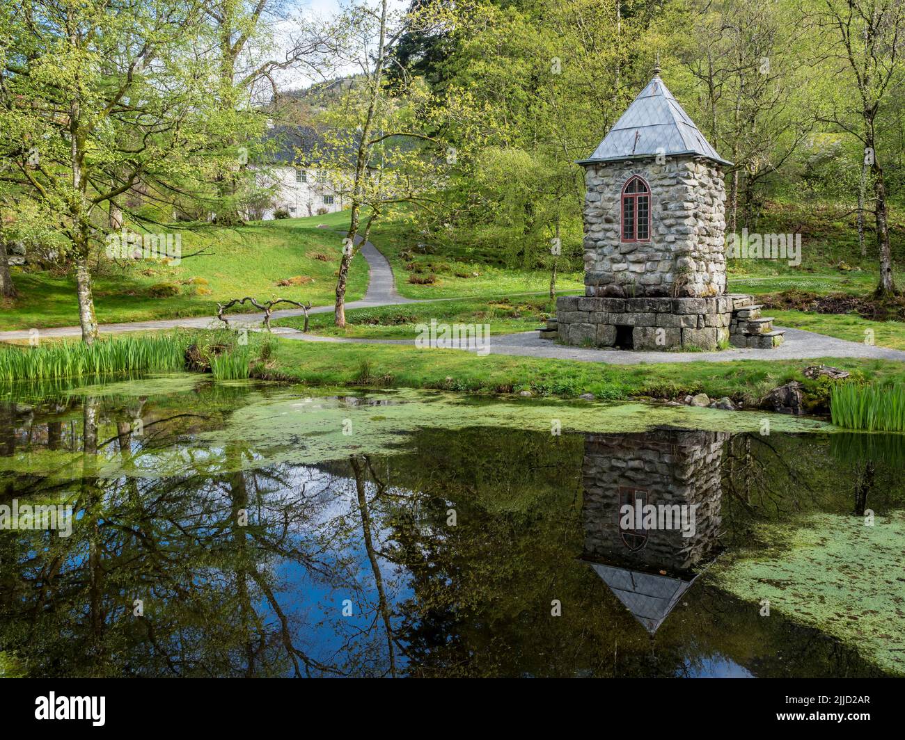 Springtime at the park of baroniet Rosendal, pond with tower, old castle, Rogaland, Norway. Stock Photo