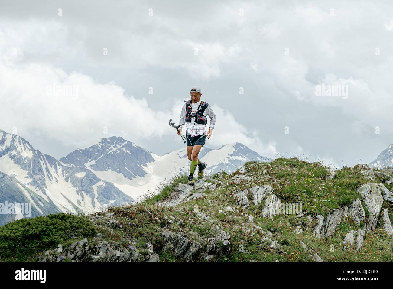 Arkhyz, Russia - July 2, 2022: male athlete running mountain trail in Arkhyz X Run Stock Photo