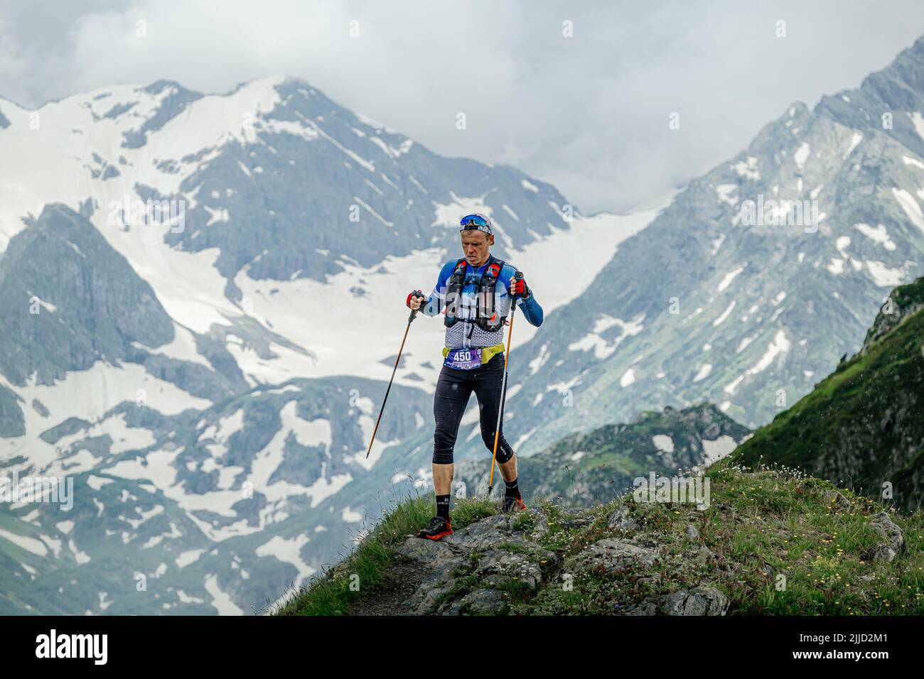 Arkhyz, Russia - July 2, 2022: male athlete walking mountain trail in Arkhyz X Run Stock Photo