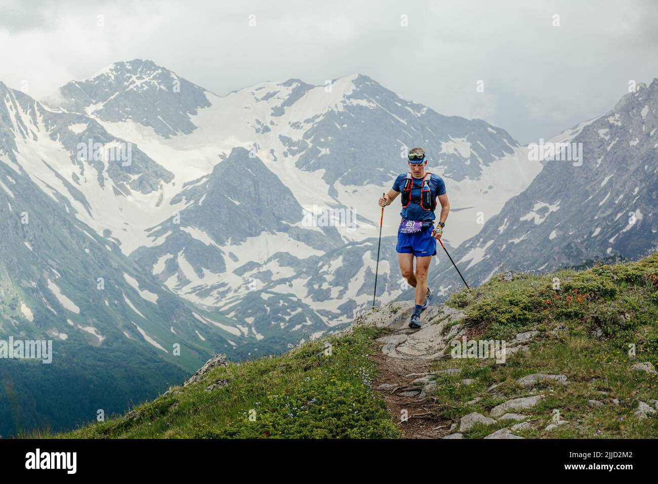 Arkhyz, Russia - July 2, 2022: male athlete walking mountain trail in Arkhyz X Run Stock Photo