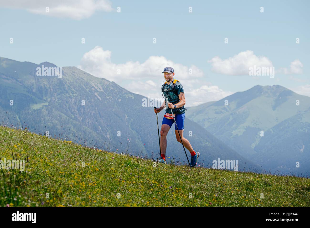 Arkhyz, Russia - July 3, 2022: male athlete walking uphill trail in Arkhyz X Run Stock Photo