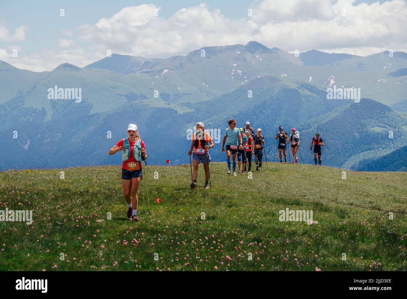Arkhyz, Russia - July 3, 2022: group athlete walking mountain trail in Arkhyz X Run Stock Photo