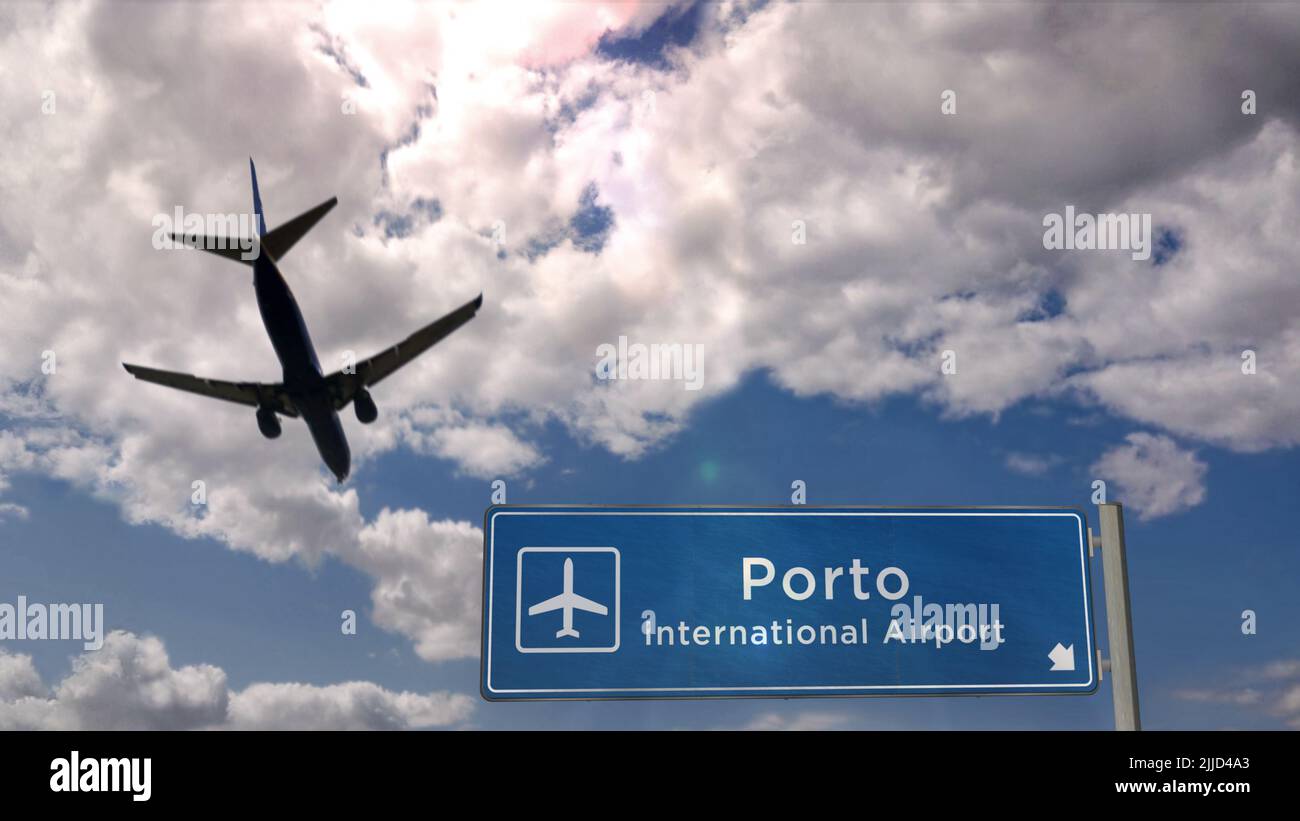 Airplane silhouette landing in Porto, Portugal. City arrival with international airport direction signboard and blue sky. Travel, trip and transport c Stock Photo