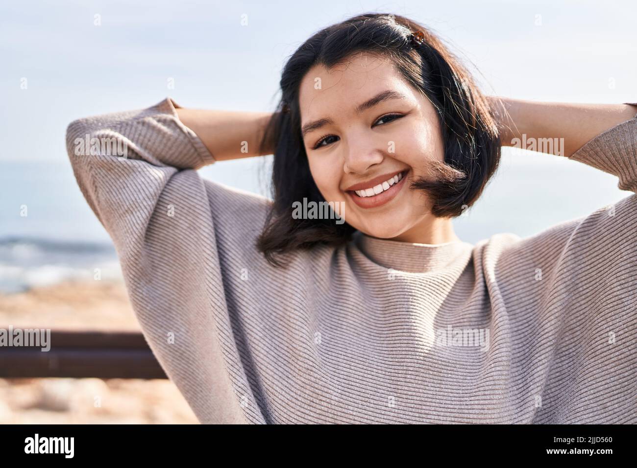 Young woman smiling confident looking to the camera at seaside Stock ...