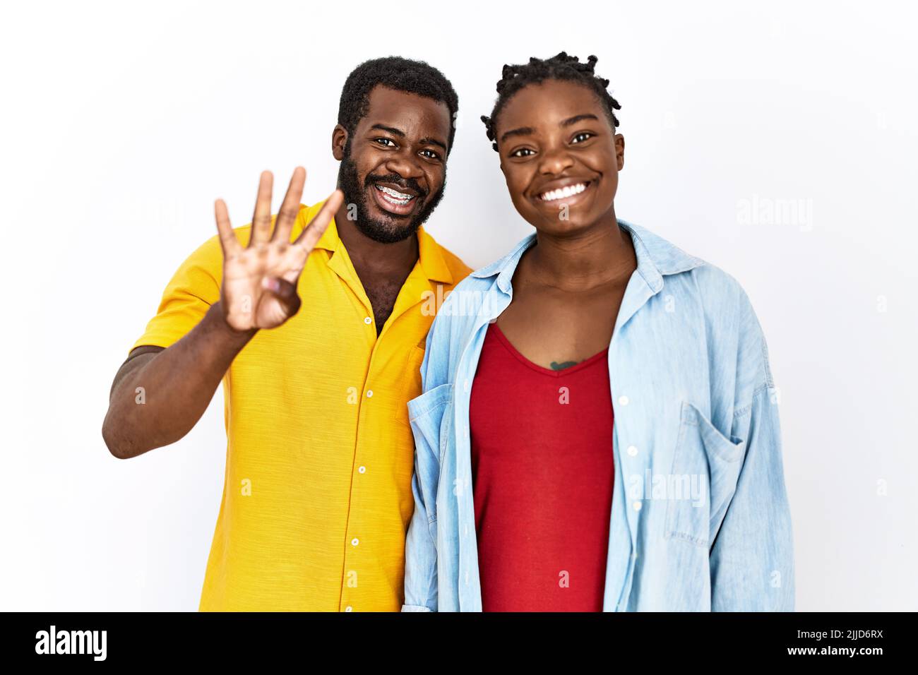 Young african american couple wearing casual clothes showing and ...