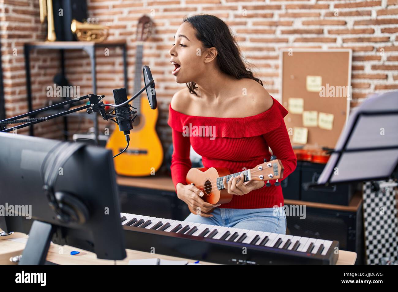 Young Africanamerican Female Singer Recording Song In The Music