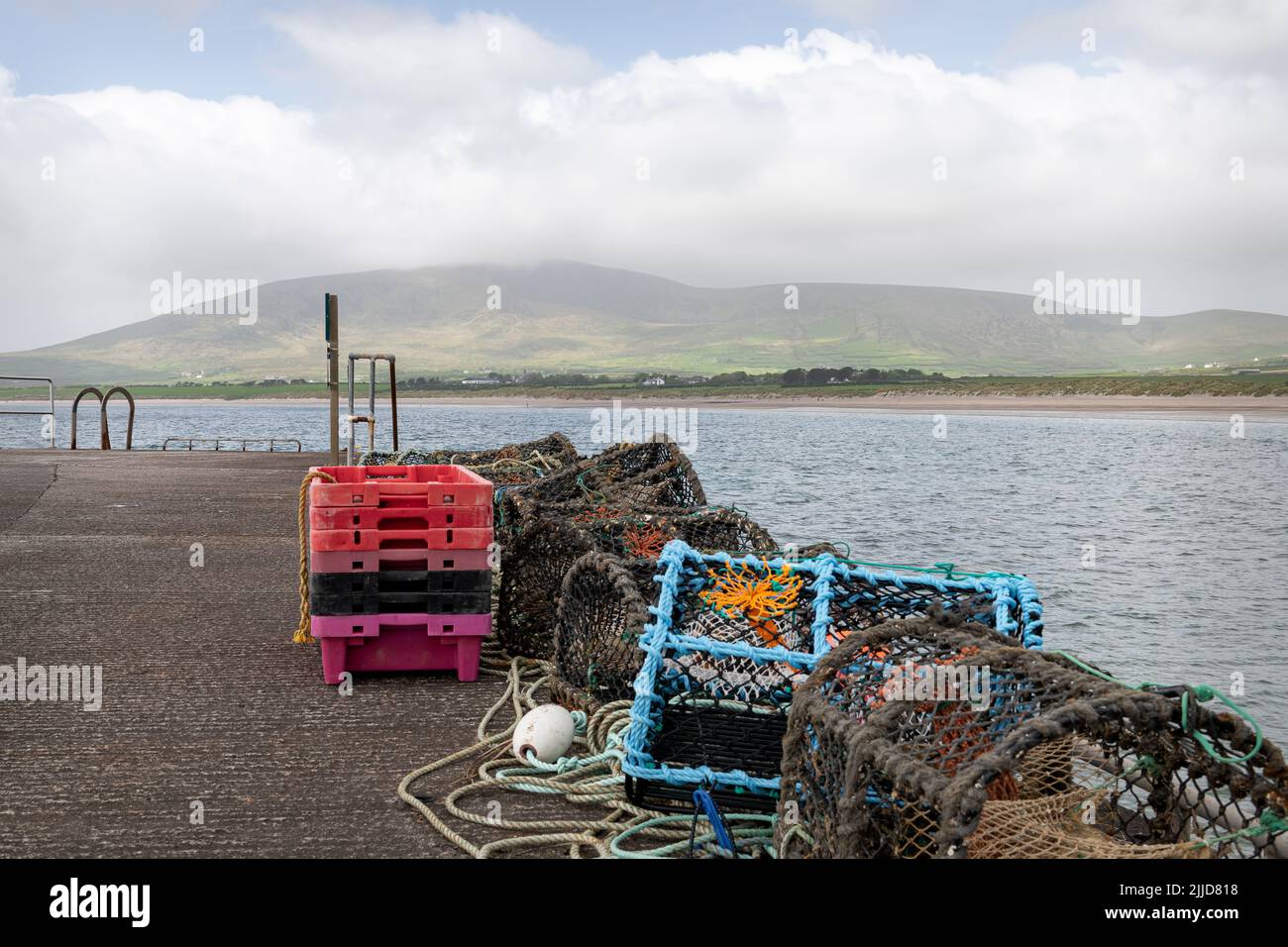 Lobster Pots and Fish Processing Trays on Ventry Pier at Ventry Harbour in County Kerry, Ireland Stock Photo
