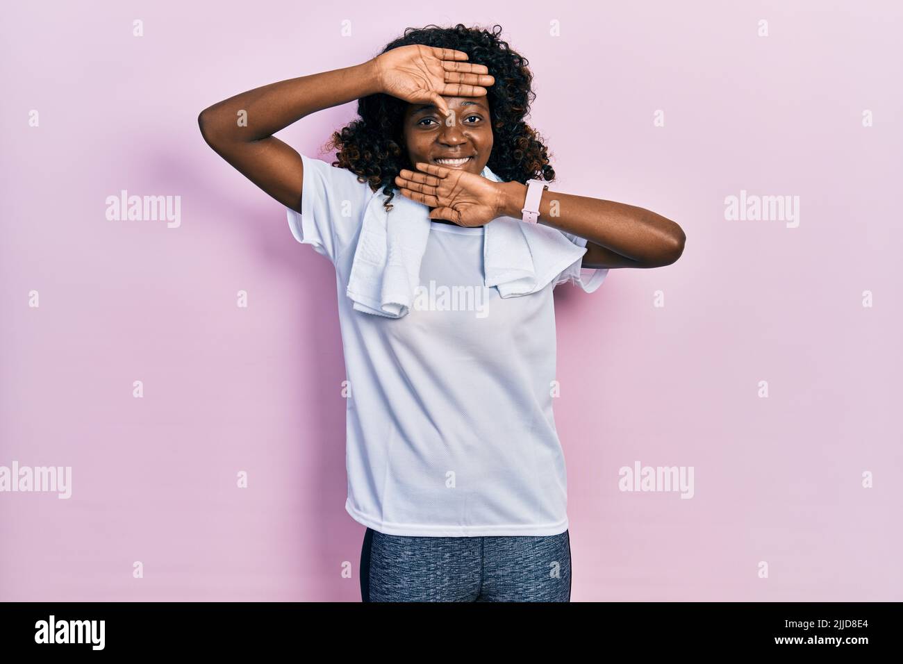 Young african american woman wearing sportswear and towel smiling ...
