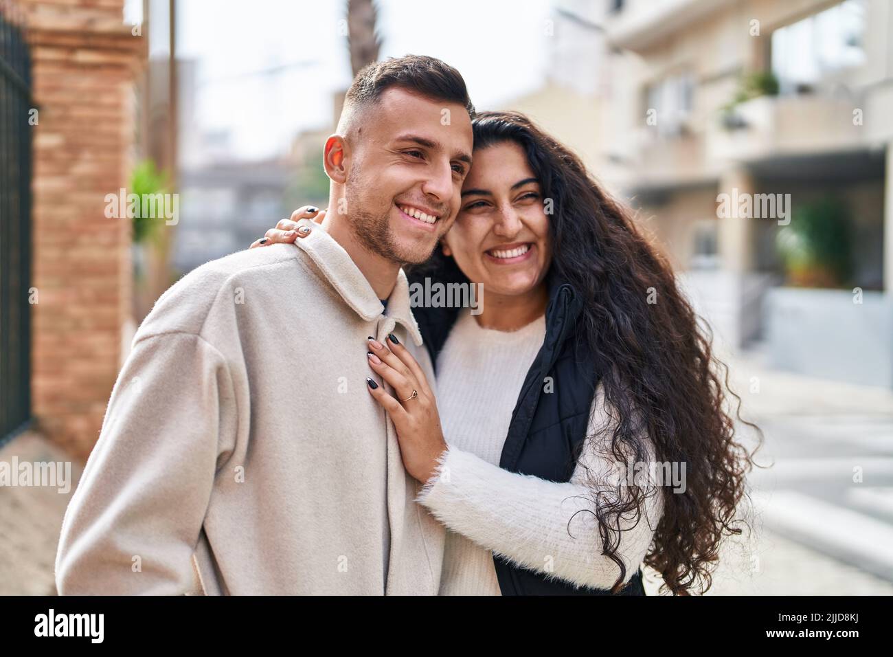 Man and woman couple hugging each other standing at street Stock Photo ...