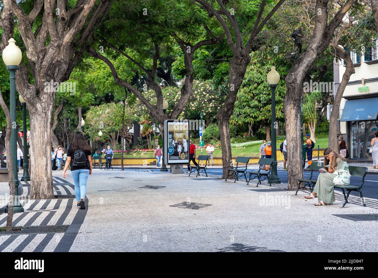 FUNSHAL, PORTUGAL - AUGUST 25, 2021: It is a pedestrian boulevard in the city center with a mosaic pattern of black and white stone sidewalk. Stock Photo