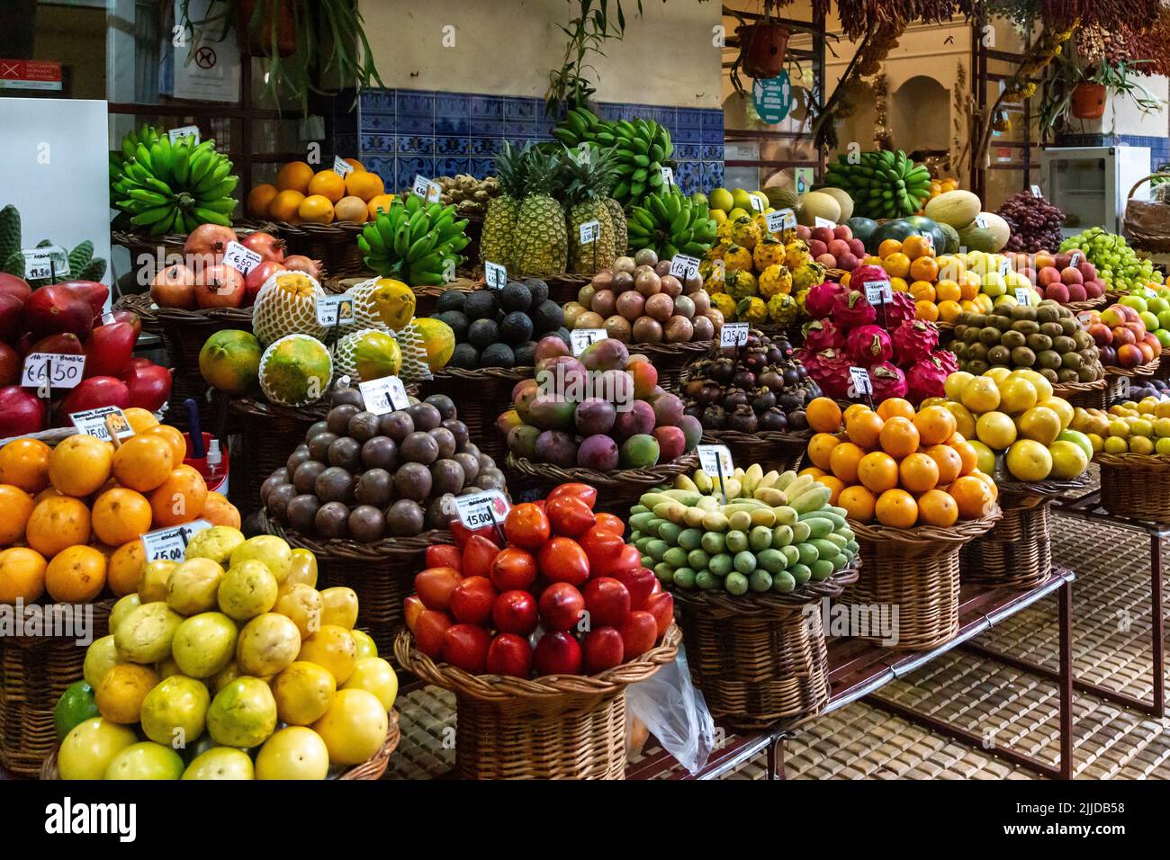 FUNCHAL, PORTUGAL - AUGUST 24, 2021: This is a stall at the Farmers Market teeming with tropical fruits. Stock Photo