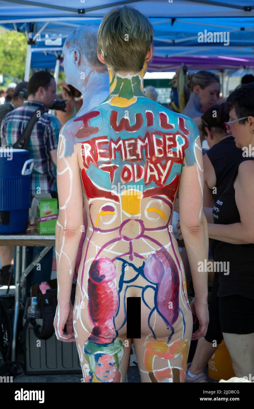 A rear view of a slender young lady at NYC Body Painting Day in Union Square Park in Lower Manhattan, New York. Stock Photo