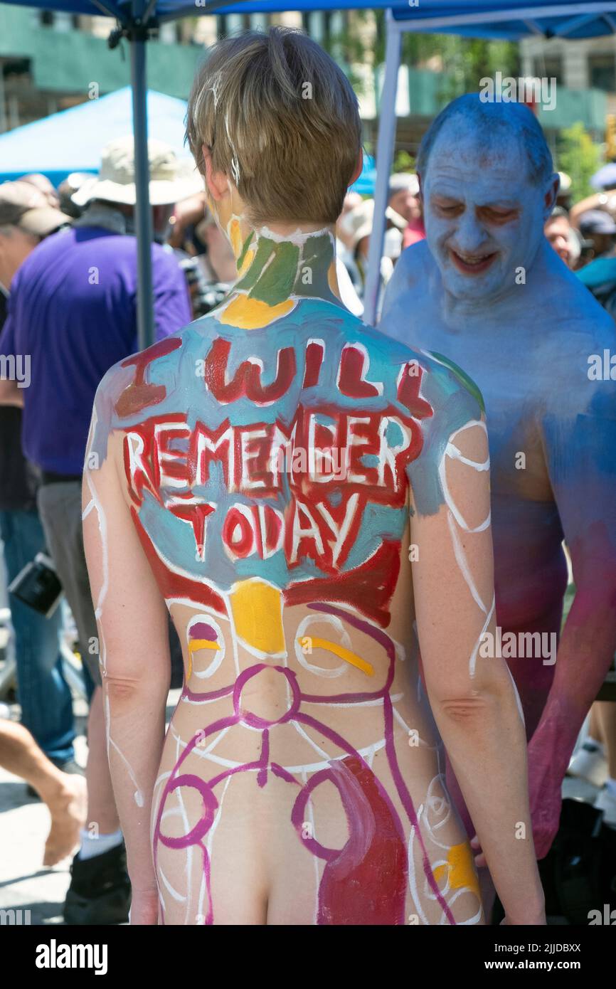 At NYC Body Painting Gay, one painted person gawks at another. In Union Square Park in Manhattan. Stock Photo
