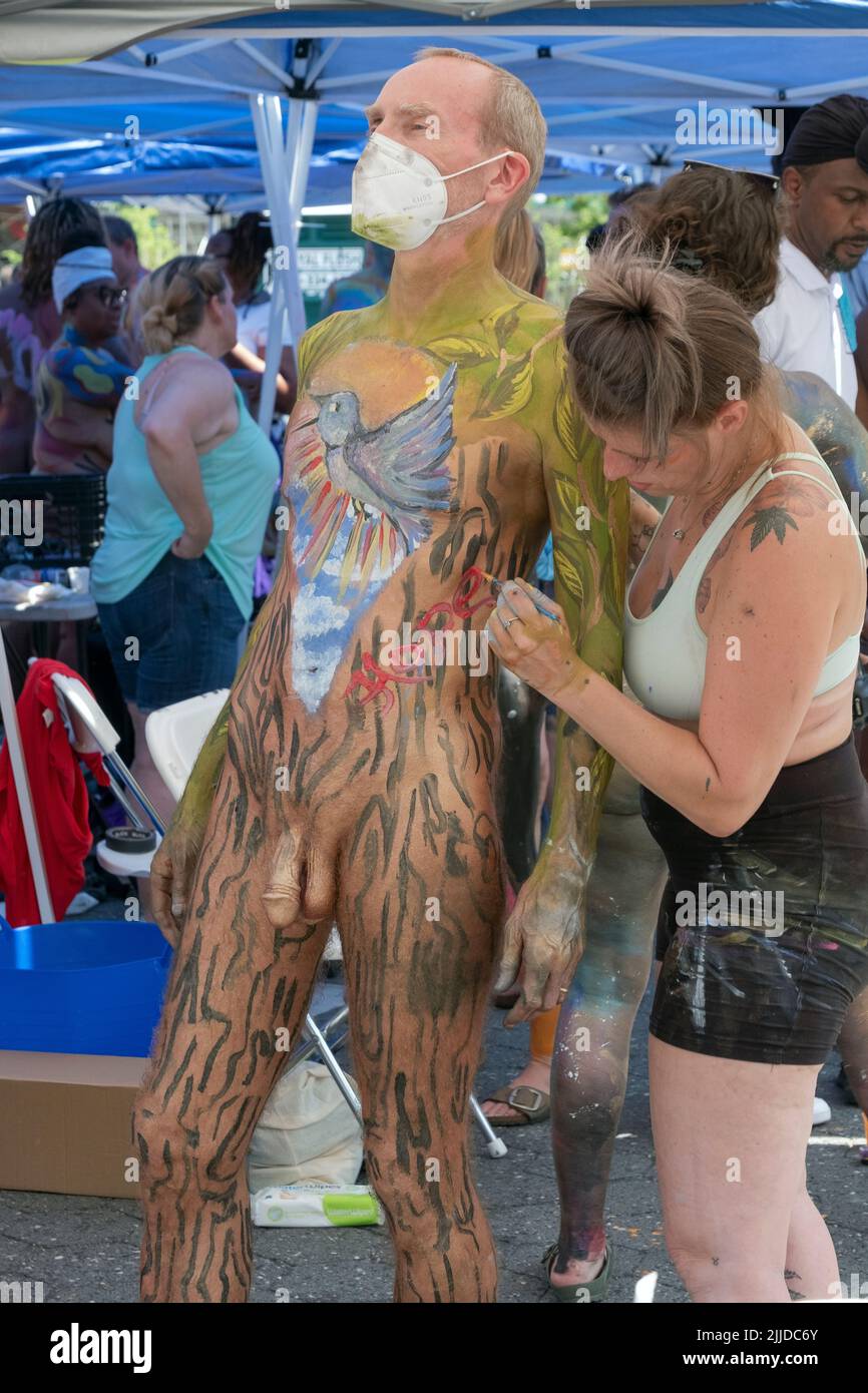 A n older man wearing a mask gets painted at NYC Body Painting Day in Union Square Park in Lower Manhattan, New York. Stock Photo