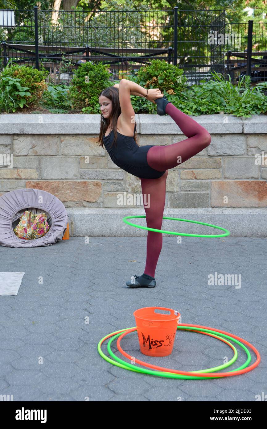 Miss 360, a street performance artist who works with hula hoops, performing at Union Square Park in New York City Stock Photo