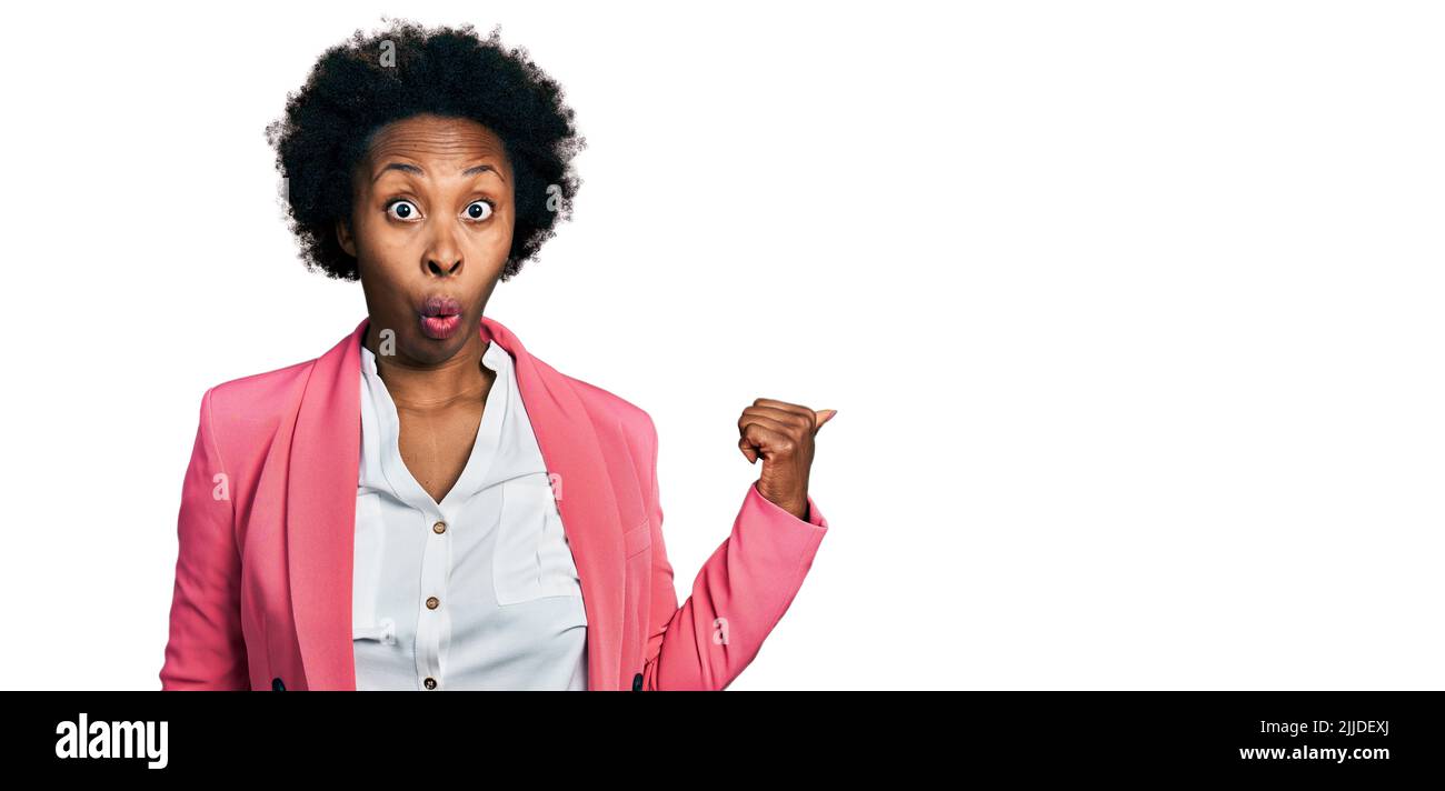 African american woman with afro hair wearing business jacket surprised ...
