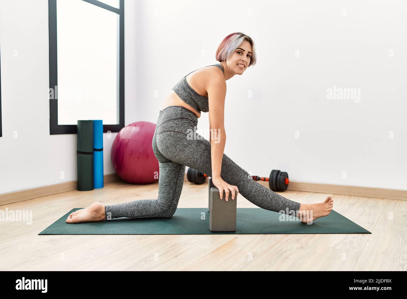 Young caucasian girl smiling happy training at sport center Stock Photo ...