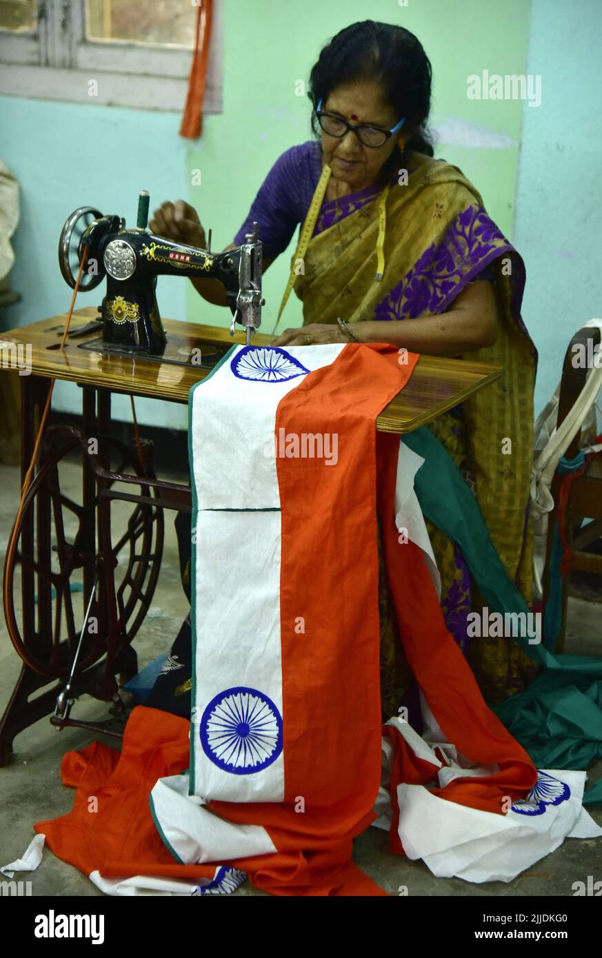 Guwahati, Guwahati, India. 25th July, 2022. A woman stitching National flags of India ahead of the celebration of the Independence Day at Assam Khadi and Village Industries Board in Guwahati Assam India on Monday 25th July 2022.India will be celebrating 75th Independence Day on 15th August 2022. (Credit Image: © Dasarath Deka/ZUMA Press Wire) Stock Photo