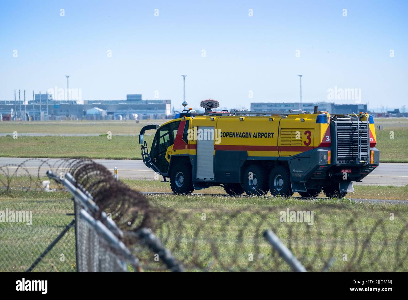 Copenhagen / DENMARK - JULY 22, 2022: An airport fire rescue vehicle at Copenhagen airport CPH, driving on the taxiway. Stock Photo