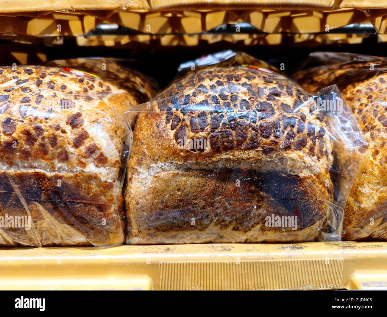 Close up of unmarked slices of bread wrapped in plastic are on a