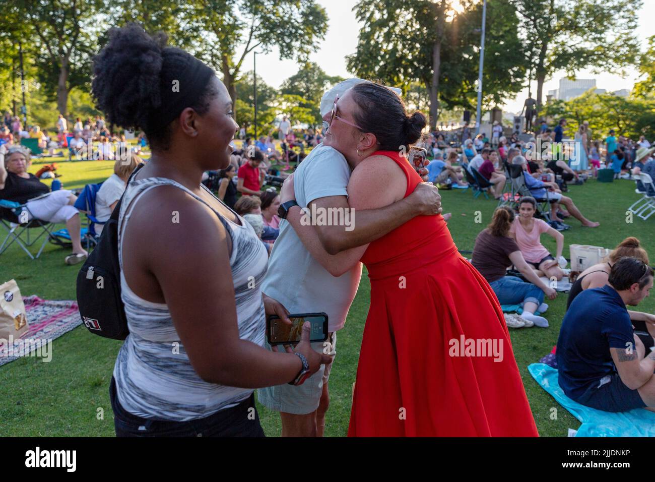 People outdoors on the Esplanade for a summer concert by the Boston Landmarks Orchestra Stock Photo