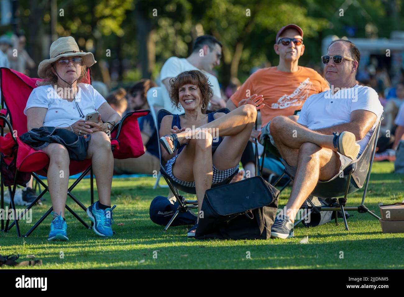 People outdoors on the Esplanade for a summer concert by the Boston Landmarks Orchestra Stock Photo