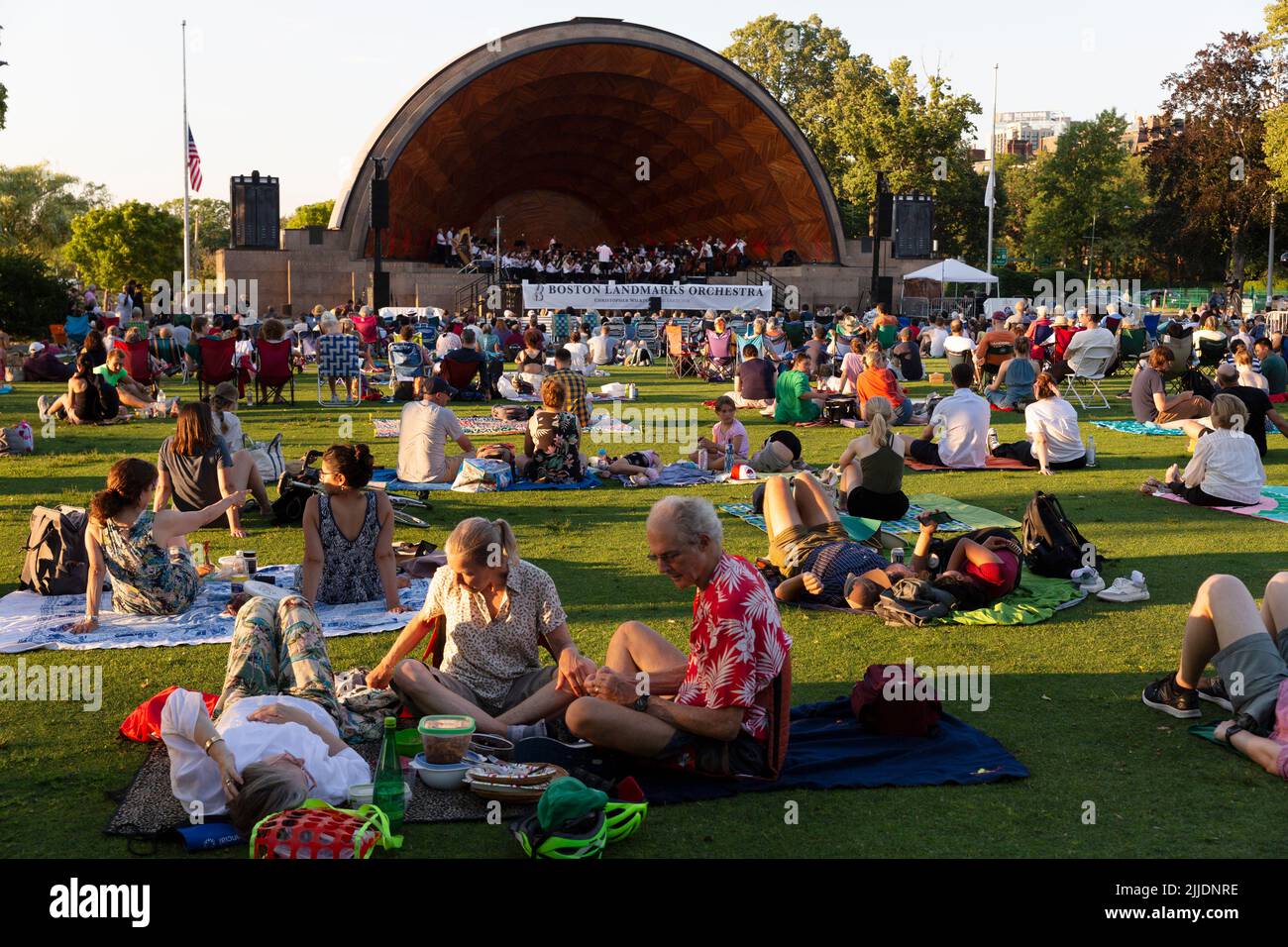 People outdoors on the Esplanade for a summer concert by the Boston Landmarks Orchestra Stock Photo