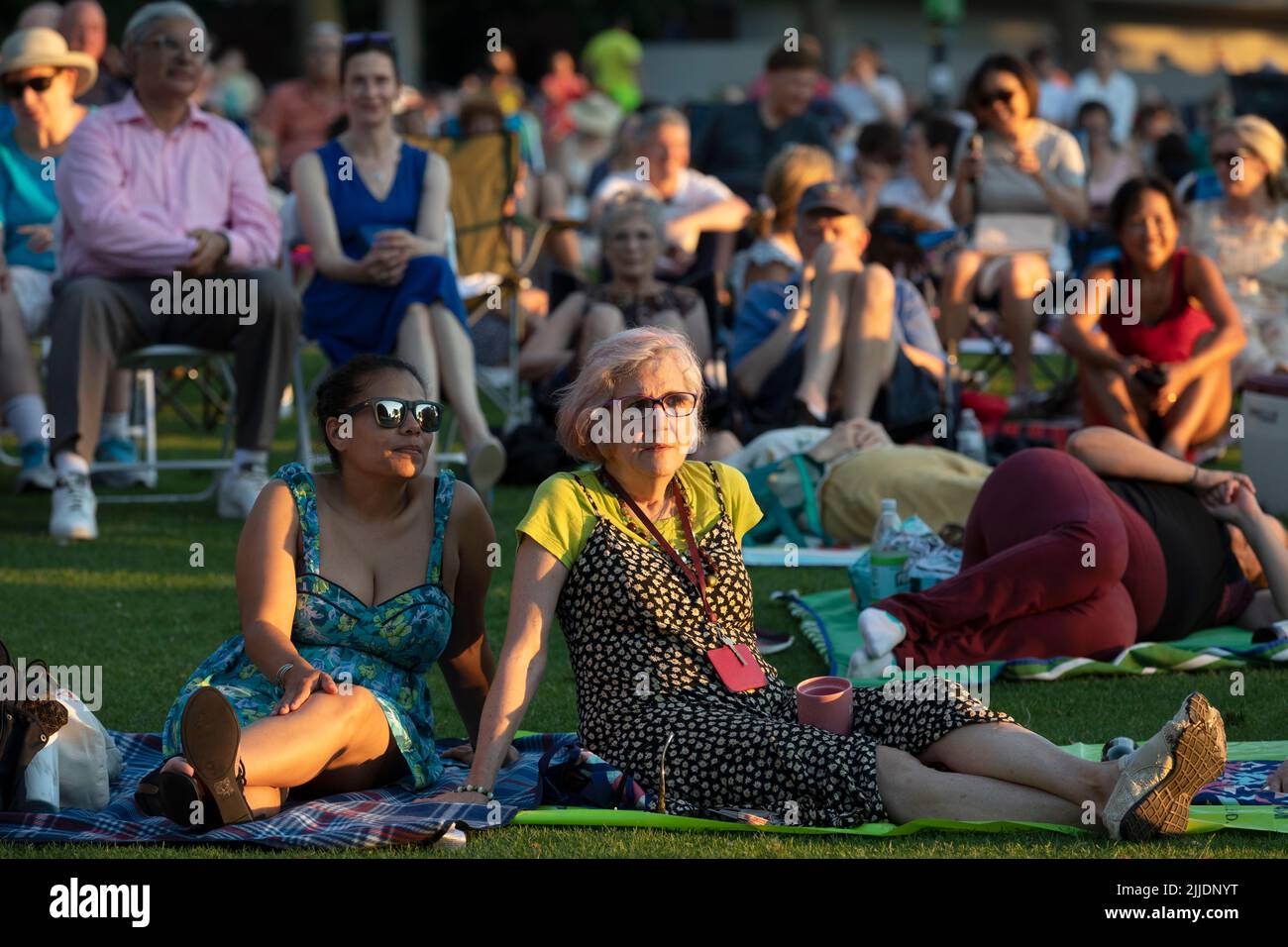 People outdoors on the Esplanade for a summer concert by the Boston Landmarks Orchestra Stock Photo