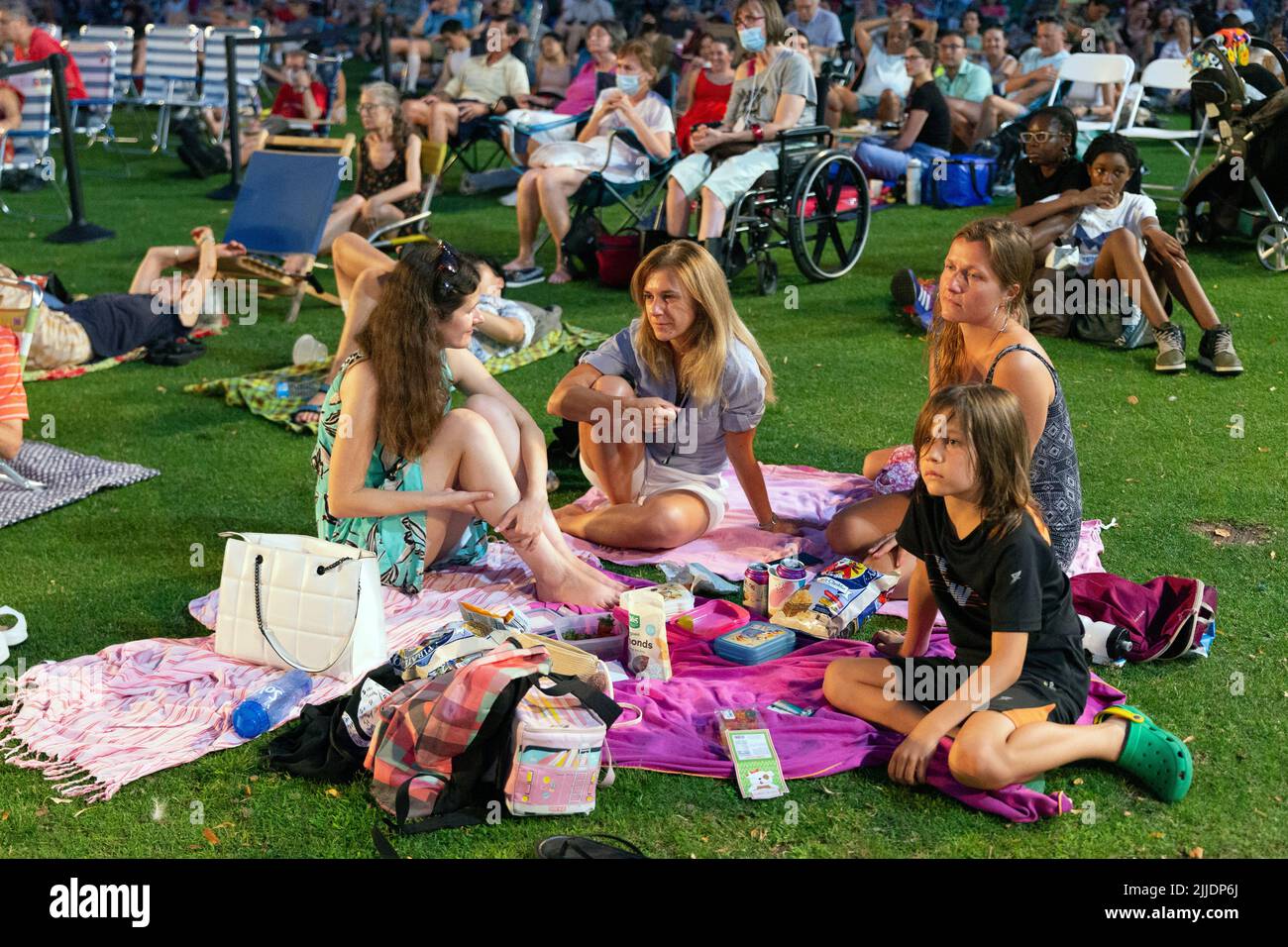 People outdoors on the Esplanade for a summer concert by the Boston Landmarks Orchestra Stock Photo