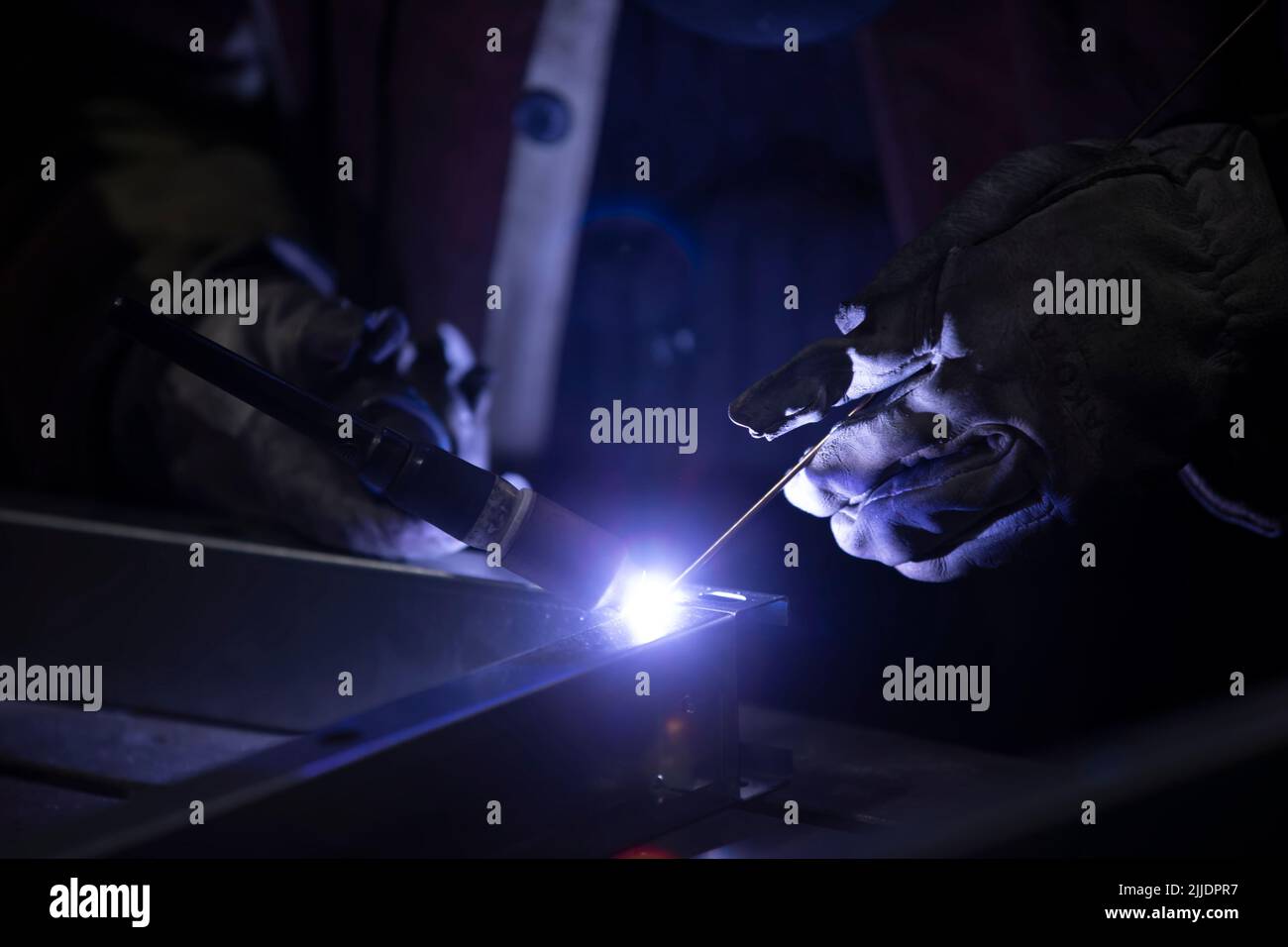 Weld a metal seam with argon arc welding. Welding works on metal Stock