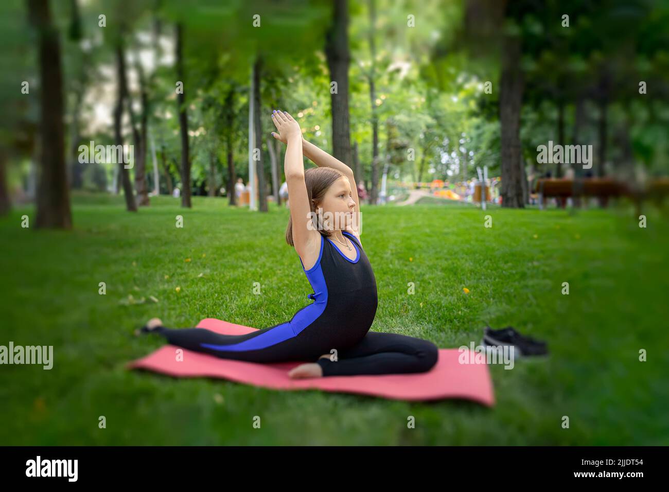 Active little girl doing yoga Stock Photo by ©vetkit 89951738