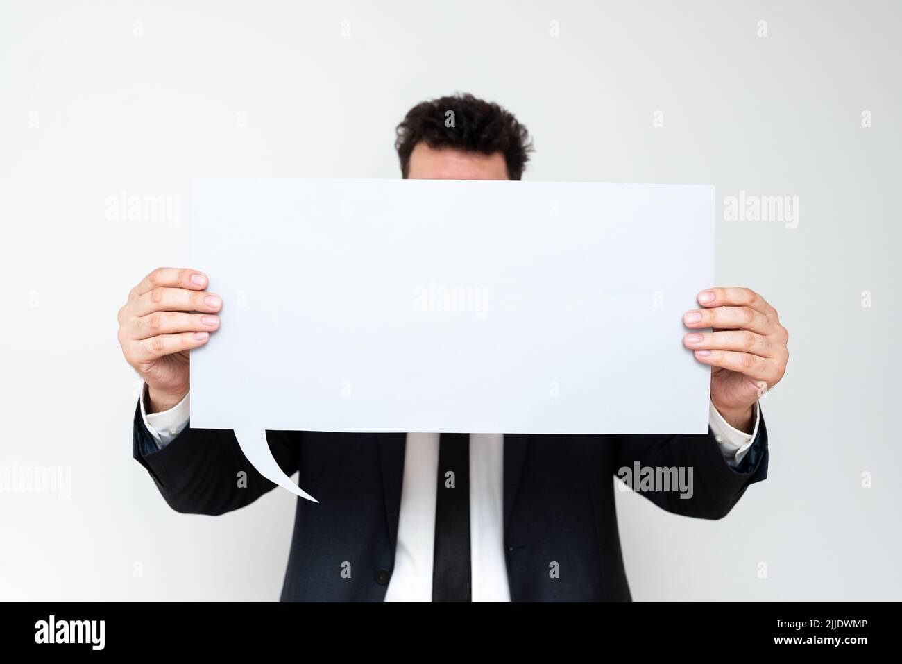 Businessman Holding Speech Bubble With Important Informations. Stock Photo