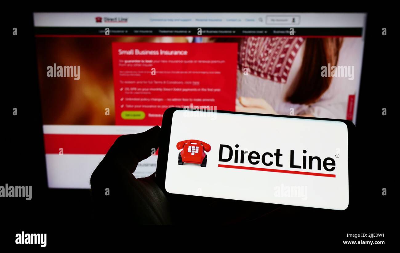 Person holding cellphone with logo of company U K Insurance Limited