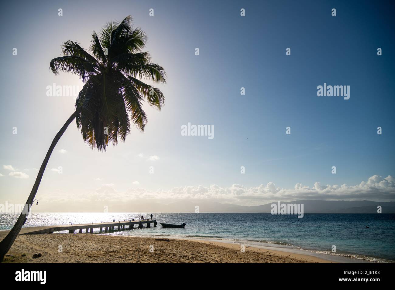 A pier with a boat on an island in the San Blas Islands in Panama Stock Photo