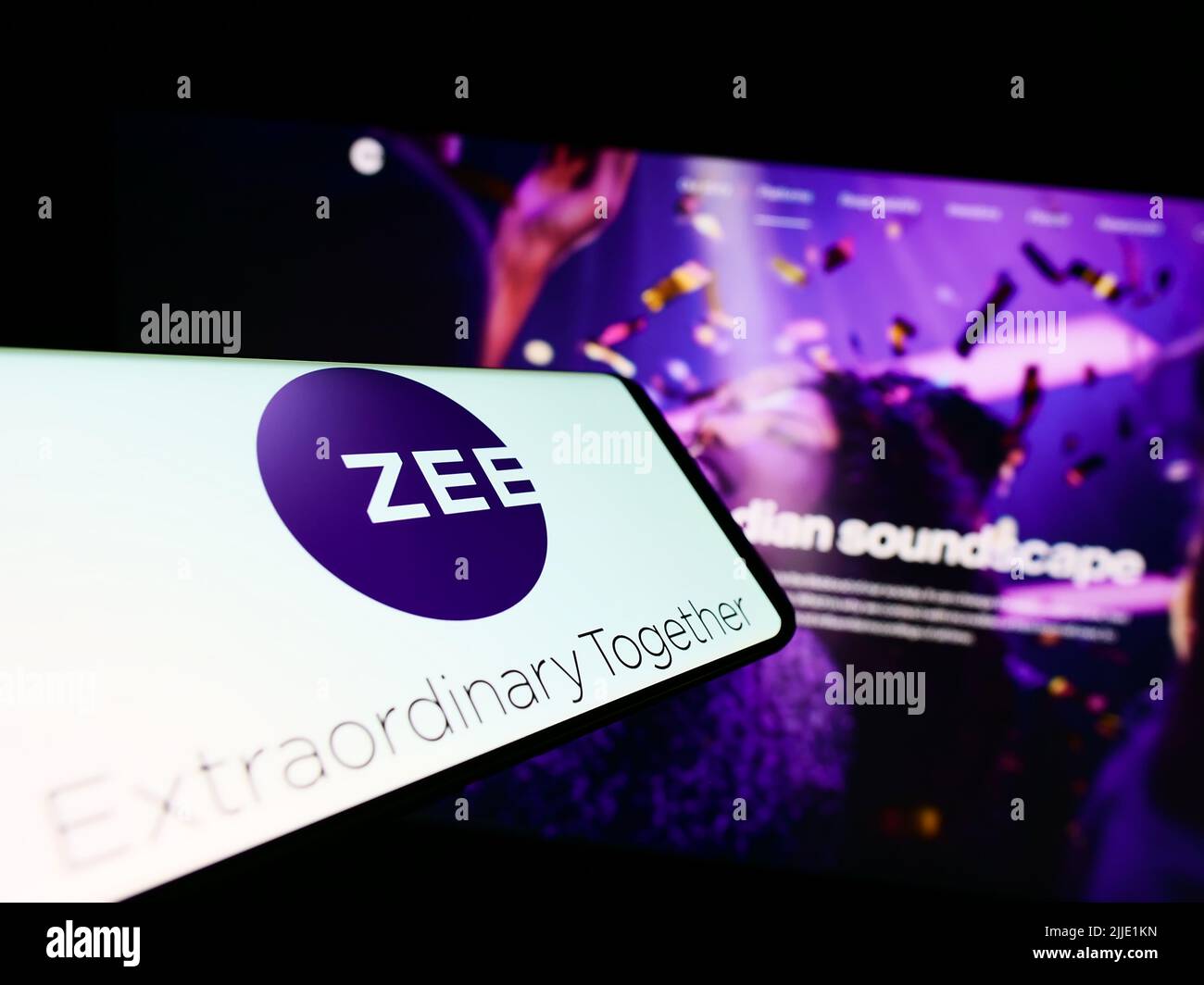 Smartphone with logo of company Zee Entertainment Enterprises Limited on screen in front of business website. Focus on right of phone display. Stock Photo