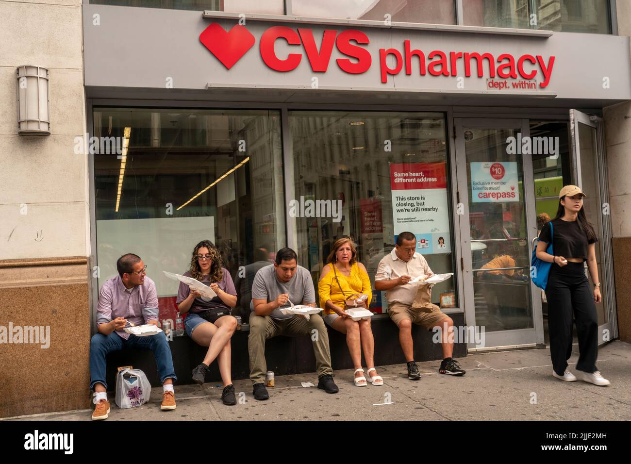 Visitors to a street fair outside of a CVS Health pharmacy in Chelsea ...
