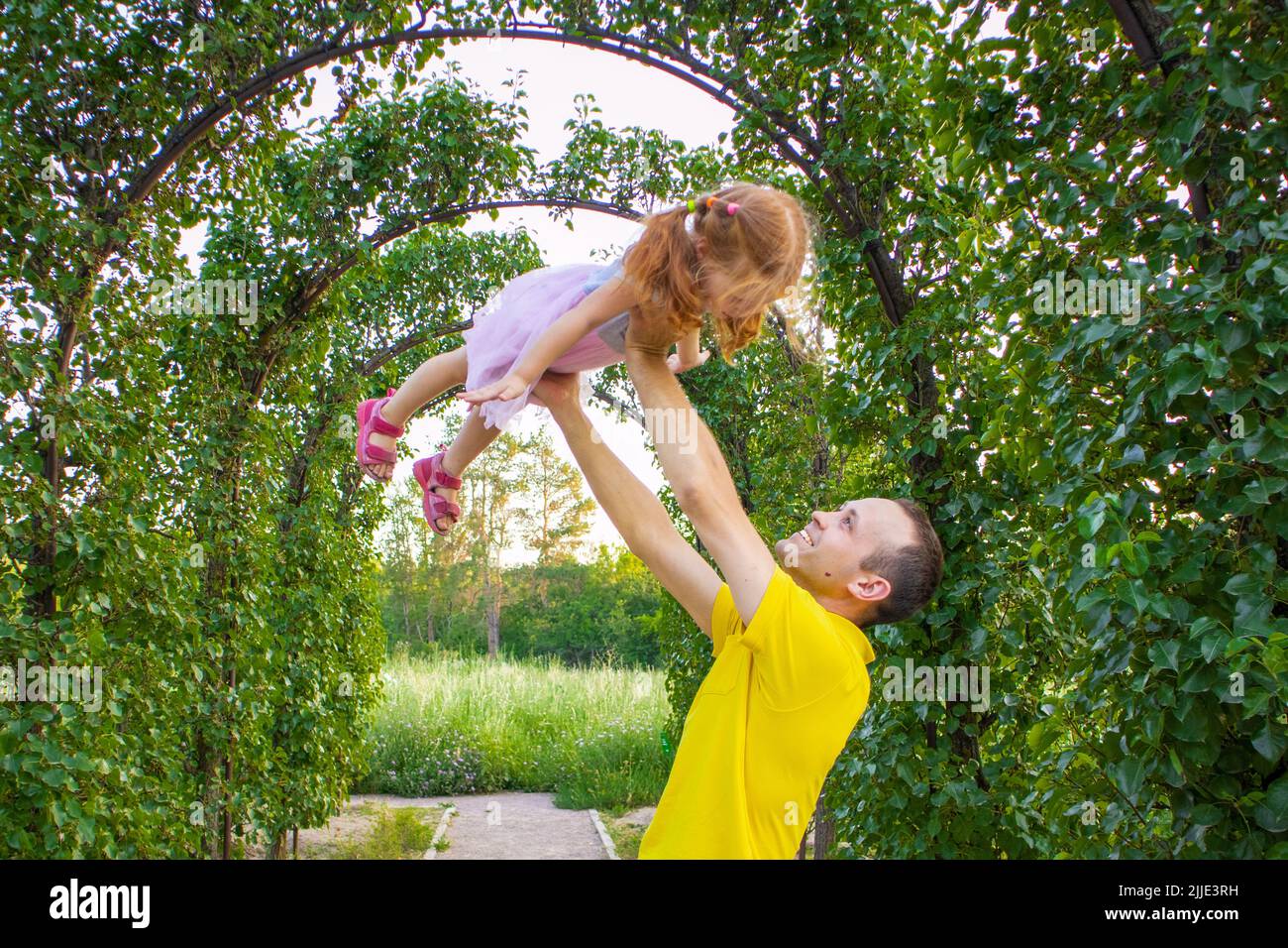 dad and daughter are dancing in nature.a little ballerina dances with her dad. little princess.dad holds his daughter in his arms. dance support Stock Photo