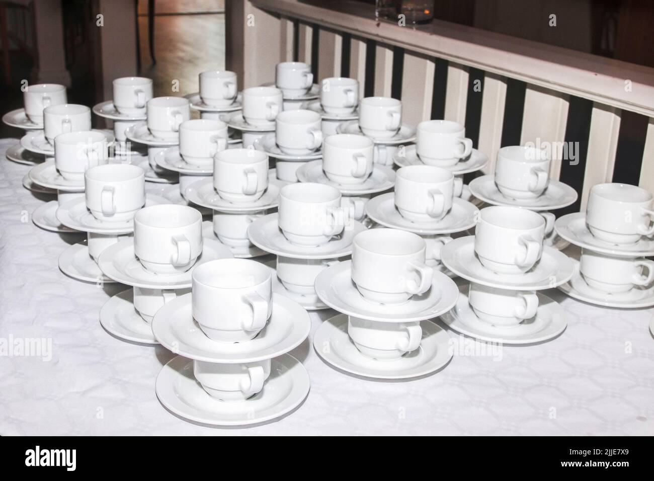 bar at an outdoor ceremony. Lots of cups and saucers on the table