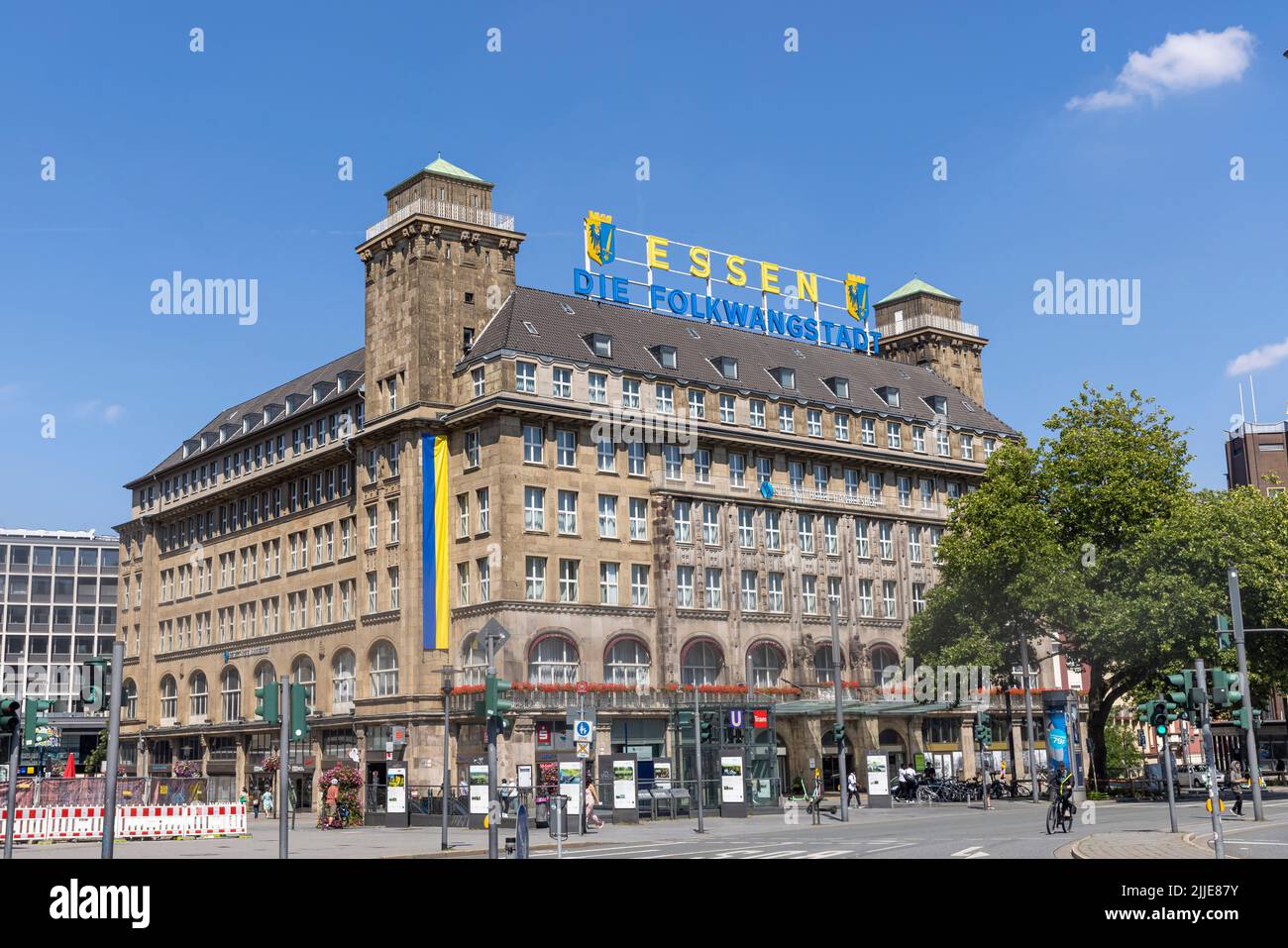People walking in front of a prominent hotel building in Essen, Germany Stock Photo