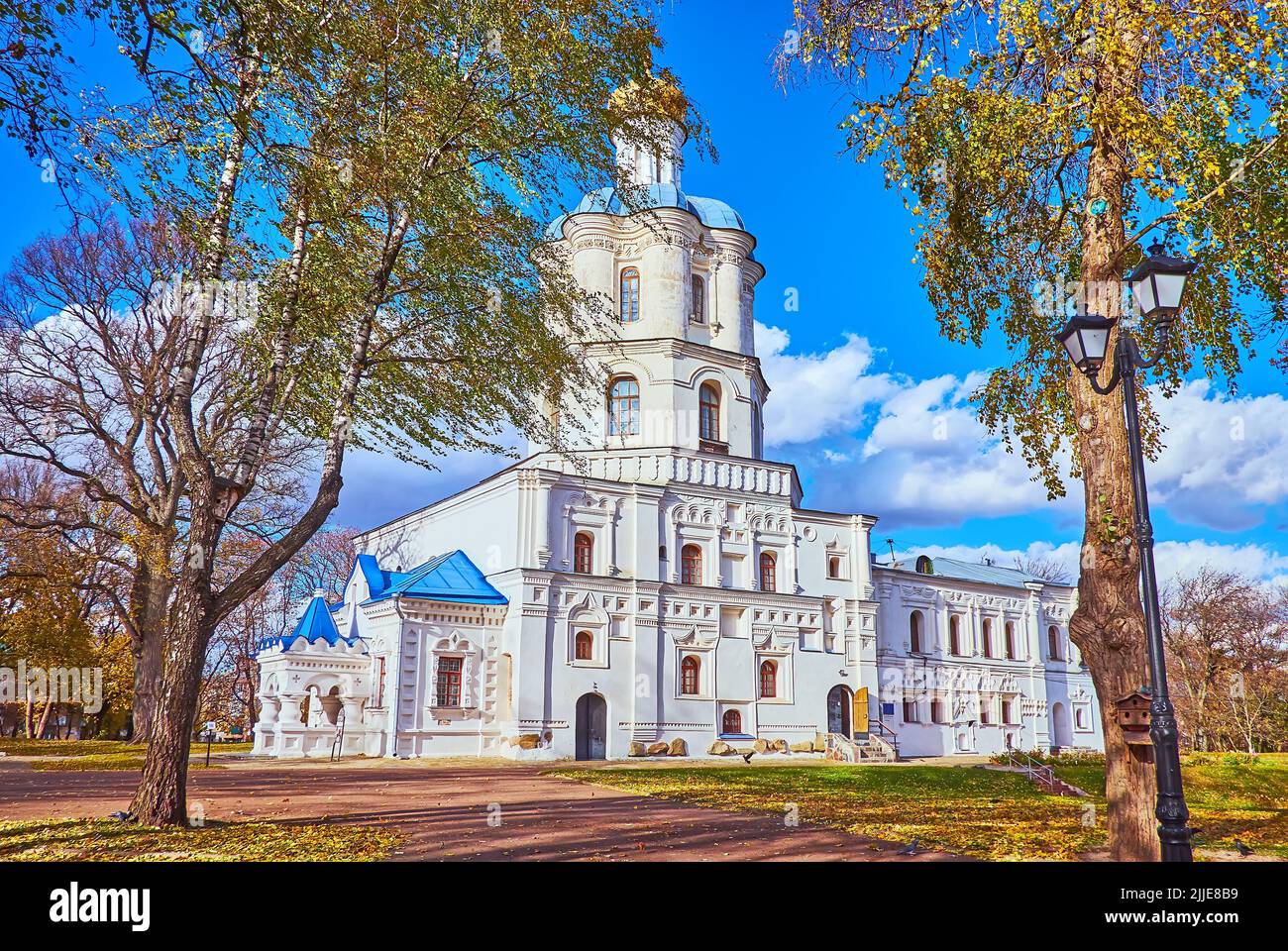 The medieval building of Chernihiv Collegium with tall autumn trees in the foreground, Chernihiv Dytynets (Chernigov Citadel) Park, Chernihiv, Ukraine Stock Photo