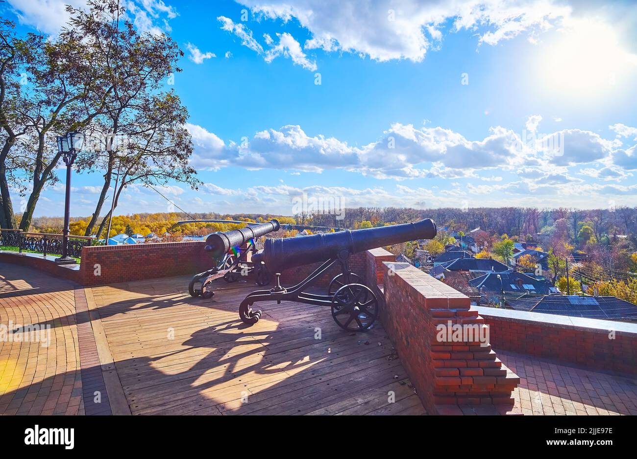 The sunny day in Chernihiv Dytynets citadel with a view on vintage cannons at the brick rampart, Chernihiv, Ukraine Stock Photo