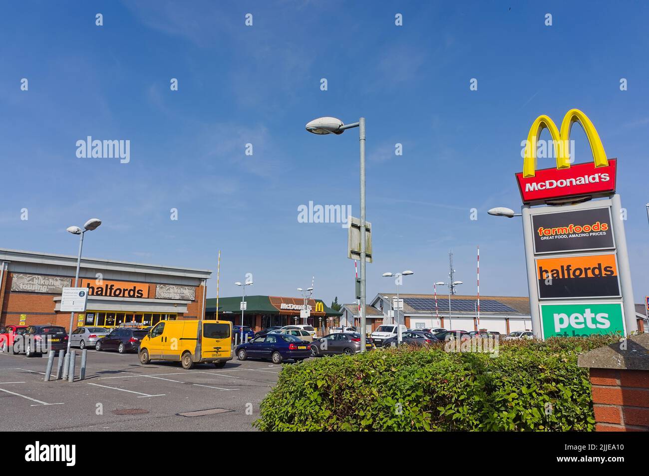 Queen Street Retail Park with billboard sign in the foreground on a sunny summer's day. Stock Photo