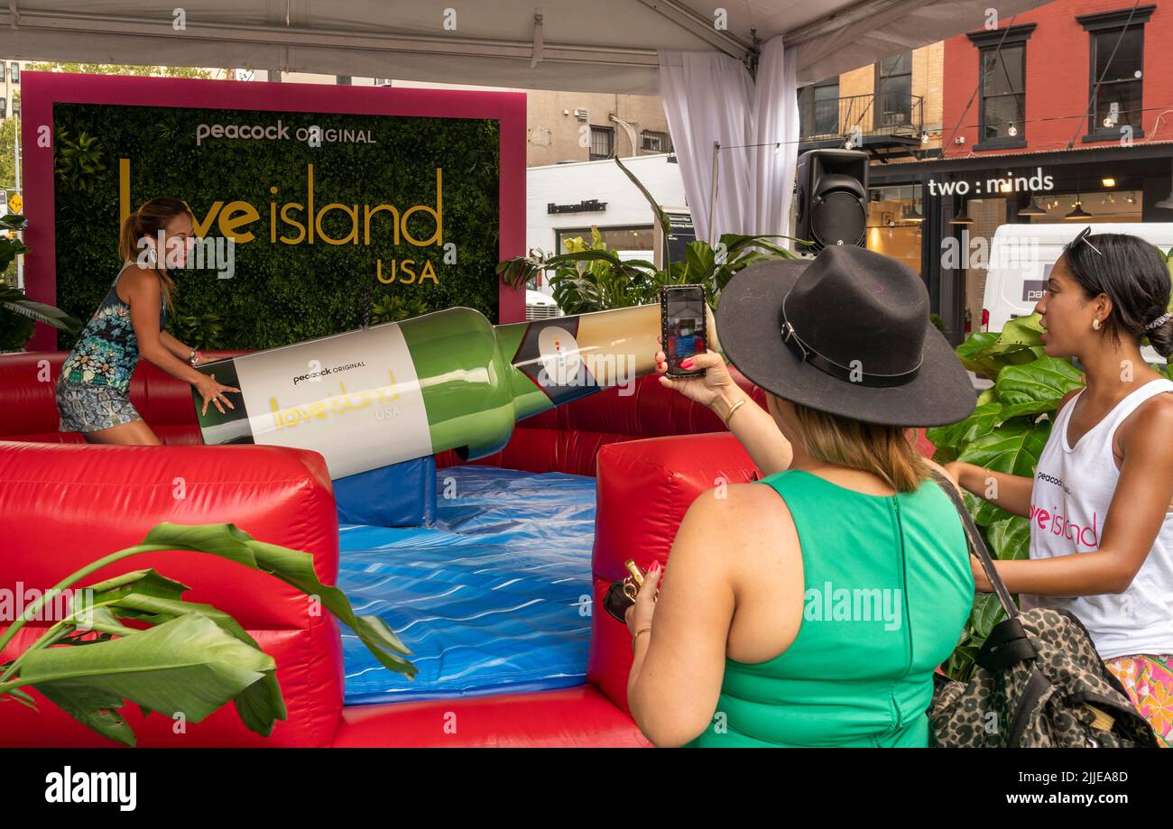 Visitors brave the excessive heat to flock to Peacock’s “Love Island: USA” brand activation in the Meatpacking District of New York on Wednesday, July, 20, 2022. Originally developed in the UK, the “reality” dating series is in its fourth season and premiered on the streaming network on July 19. (© Richard B. Levine) Stock Photo