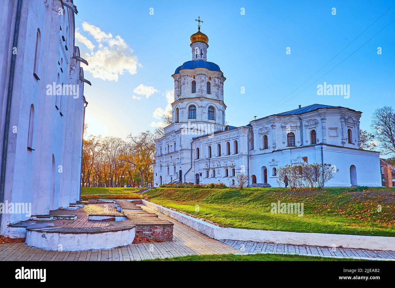 The medieval whitewashed building of Chernihiv Collegium surrounded with green lawn of Chernihiv Citadel Park, Chernihiv, Ukraine Stock Photo
