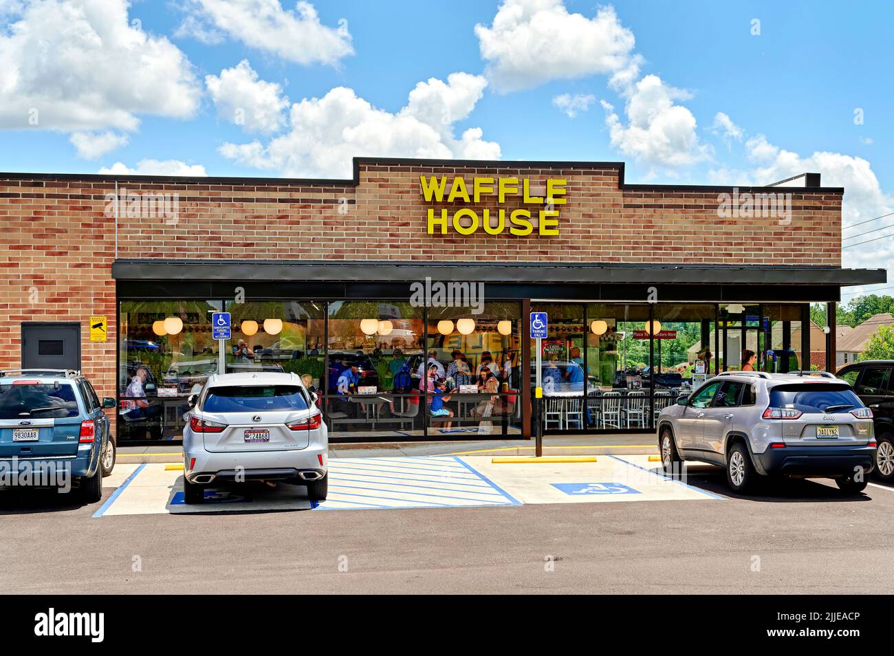 People eating in a Waffle House, a small family breakfast restaurant exterior front entrance in Pike Road Alabama, USA. Stock Photo